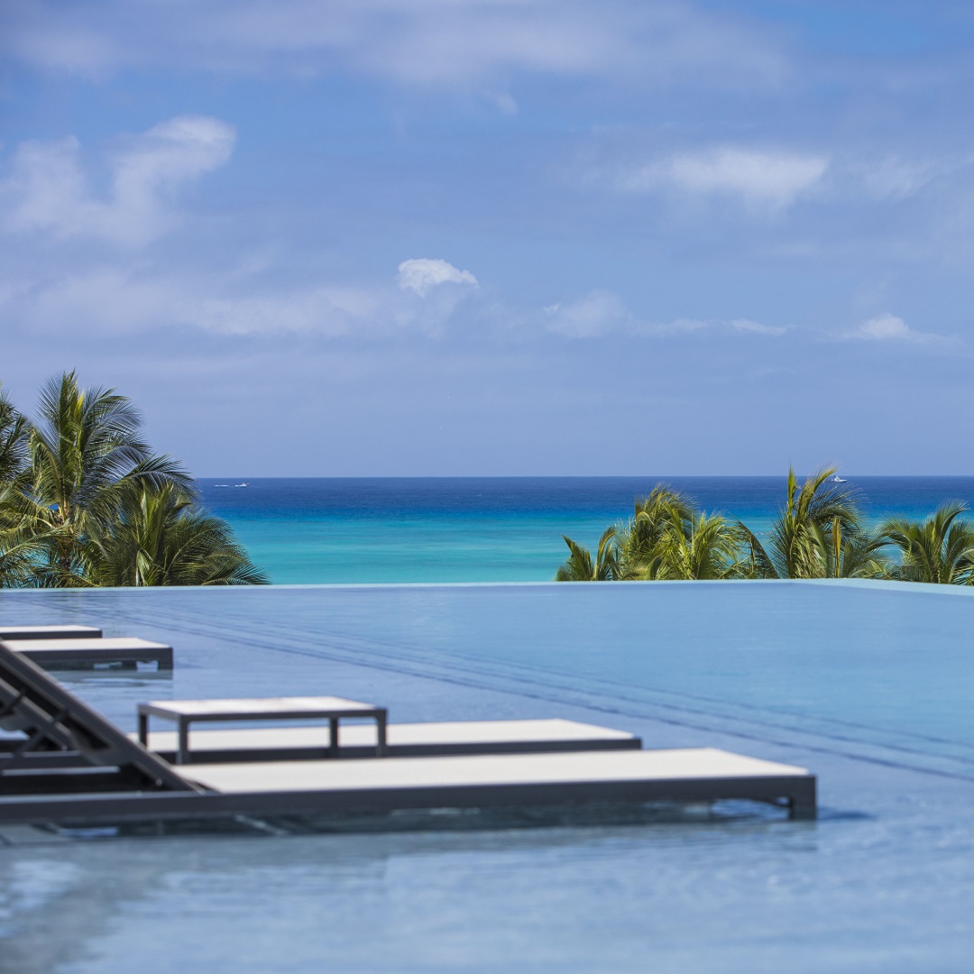 Daytime Infinity Pool with aqua loungers in pool