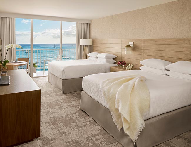 Ocean Front accommodations with two queen beds and view of ocean through lanai doors