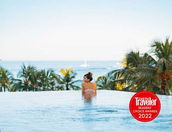 Female in infinity pool overlooking the ocean