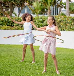 two girls playing with hula hoops